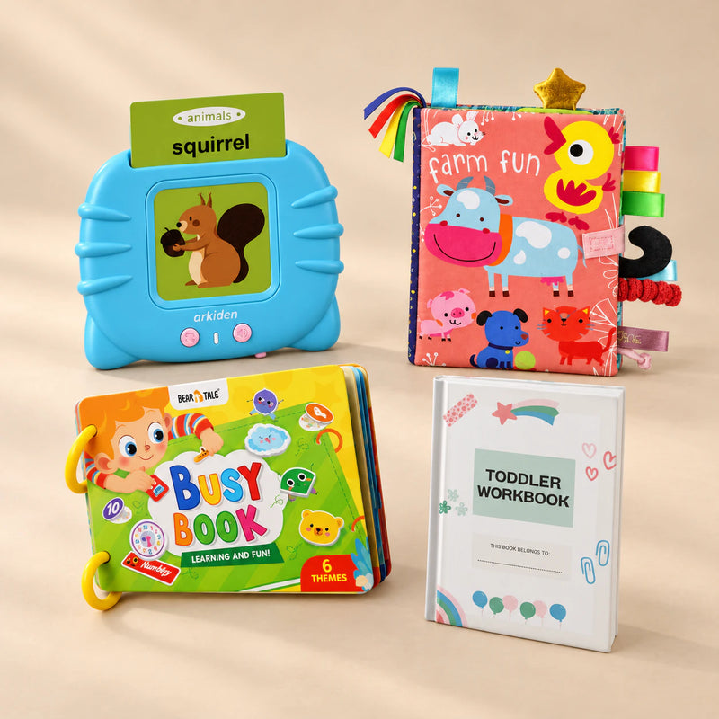 First Words Bundle with its matching toys and books arranged together on a softly lit warm beige studio surface.