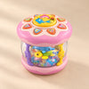 Pink Crawl and Glow musical rolling toy with a transparent ocean scene, photographed on a warm beige studio surface.