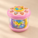 Pink Crawl and Glow musical rolling toy with a transparent ocean scene, photographed on a warm beige studio surface.