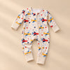 Soft Zip Baby Romper, showing its actual design with soft shadows on a seamless warm beige studio surface.