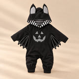Little Bat Hooded Romper on a warm beige studio background in Pumpkin Bat Romper