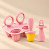 Little Bites Silicone Feeder and Teether Set in Blush Pink with mould tray on a warm beige studio background