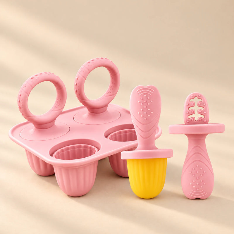 Little Bites Silicone Feeder and Teether Set in Blush Pink with mould tray on a warm beige studio background