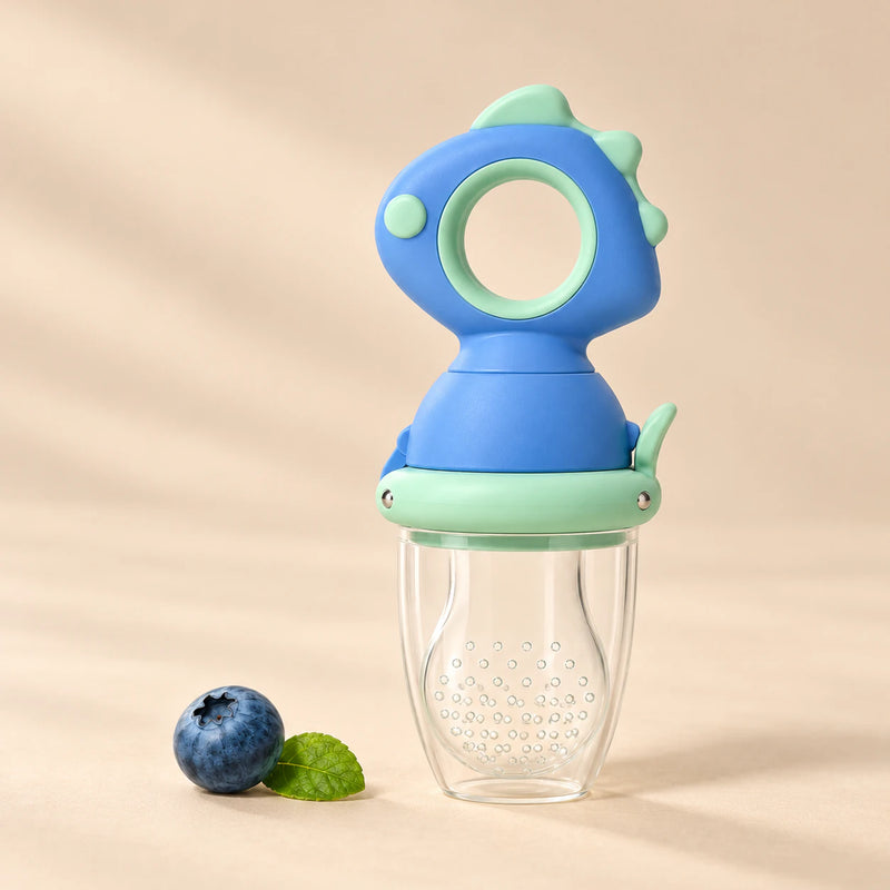 Dino Fresh Food Feeder on a warm beige studio background in Sky Blue Dino