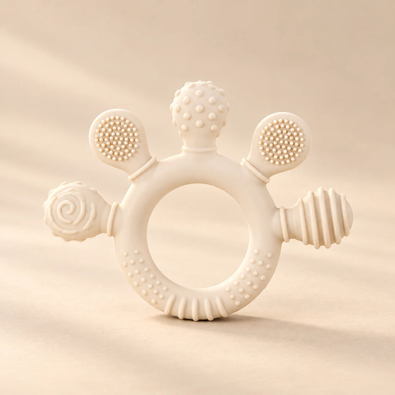 LittleGrip Silicone Teether Rattle on a warm beige studio background in Cream Beige Teether