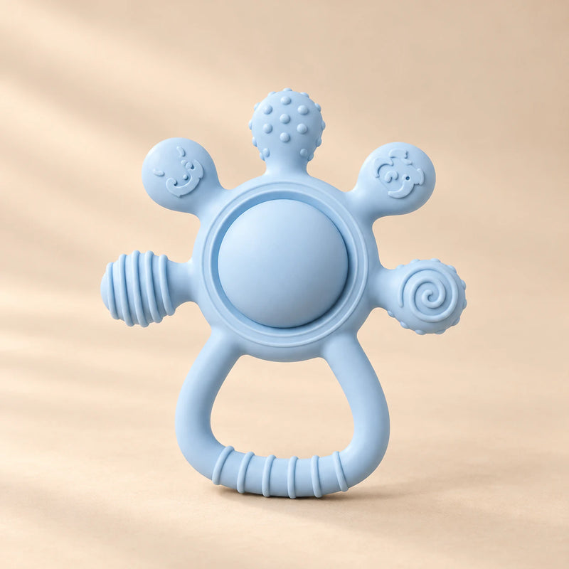 LittleGrip Silicone Teether Rattle on a warm beige studio background in Sky Blue Teether