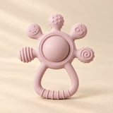 LittleGrip Silicone Teether Rattle on a warm beige studio background in Blush Pink Teether