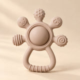 LittleGrip Silicone Teether Rattle on a warm beige studio background in Mocha Beige Teether