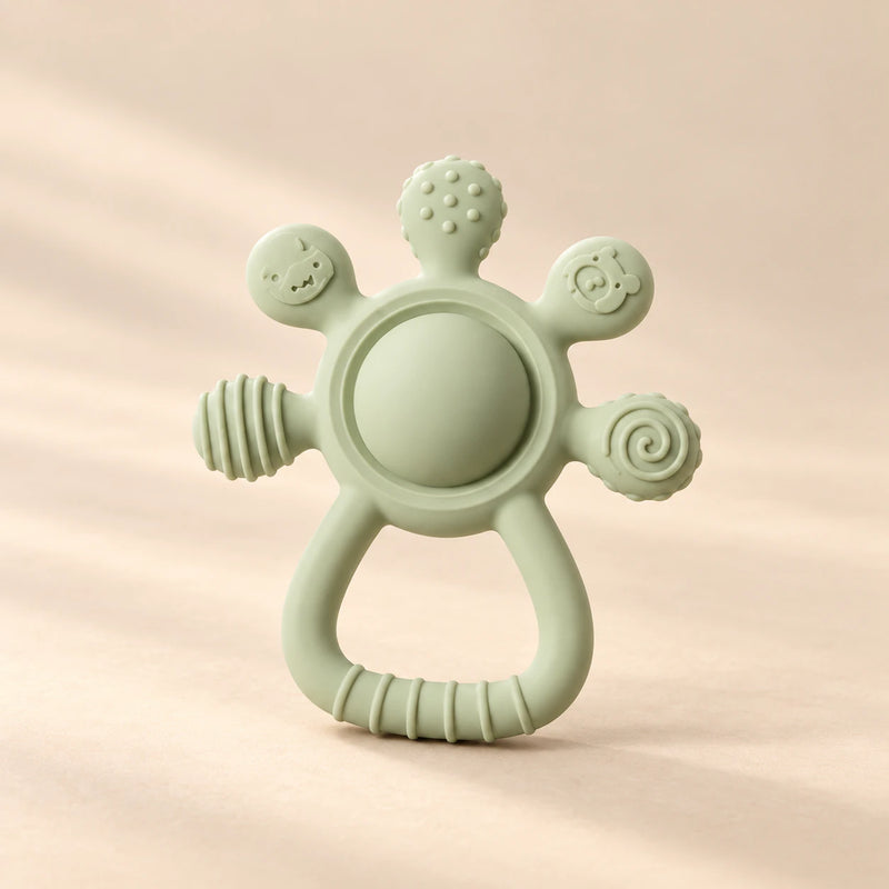 LittleGrip Silicone Teether Rattle on a warm beige studio background in Sage Green Teether
