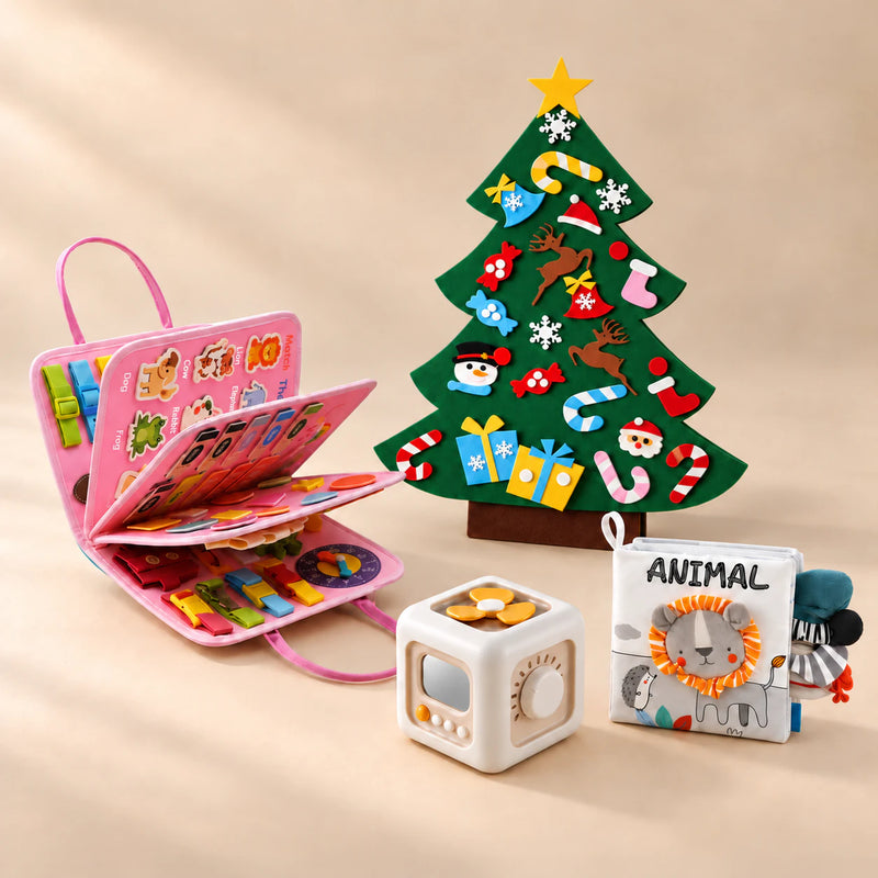 Christmas Wonder Play Bundle with the Mermaid Pink Plus busy board, arranged on a warm beige studio surface.