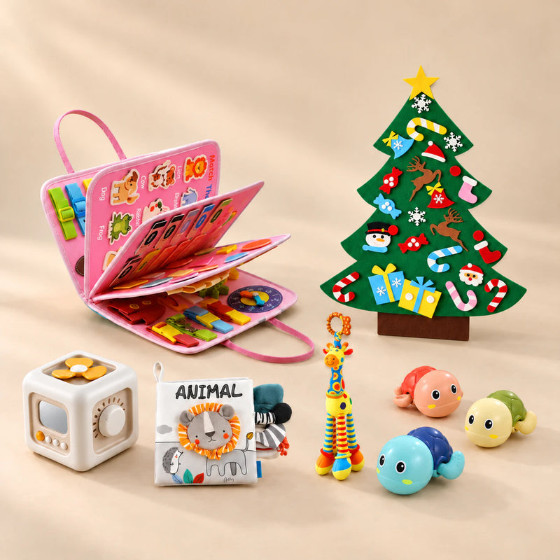 Christmas Wonder Learning Bundle with the Mermaid Pink Plus busy board, arranged on a warm beige studio surface.