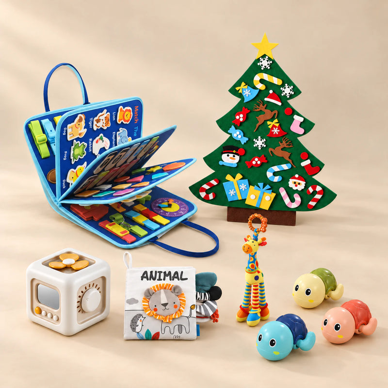 Christmas Wonder Learning Bundle with the Vehicle Blue Plus busy board, arranged on a warm beige studio surface.