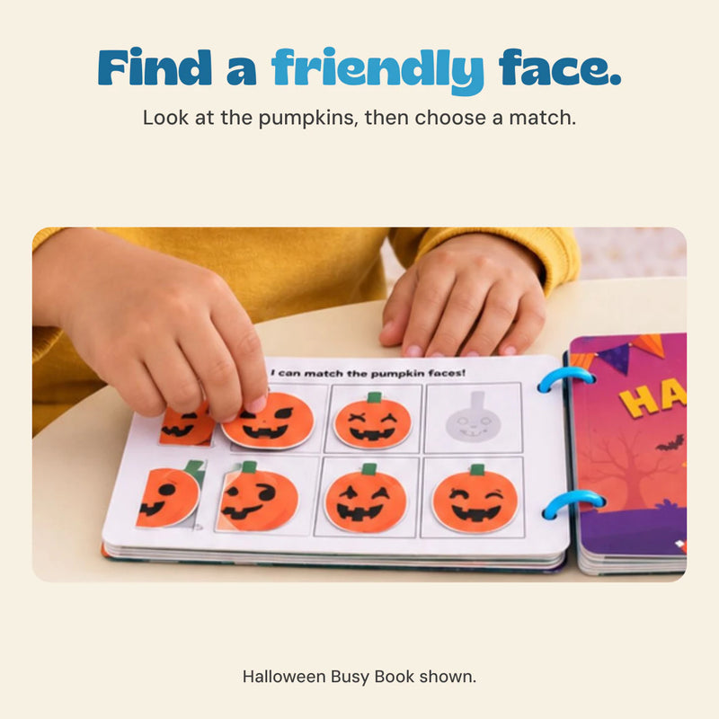 Original child hands matching the Halloween Busy Book pumpkin face pieces beside its printed cover.