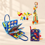 Vehicle Blue Plus Sensory Explorer Bundle with its busy board, dinosaur soft book, giraffe toy and hanging spiral toy on a warm beige background.
