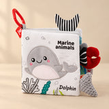 Marine Animals sensory cloth book with a plush dolphin, red clip and fabric tails.