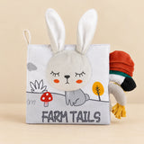 Farm Tails sensory cloth book with a plush rabbit face, soft ears and fabric tails.