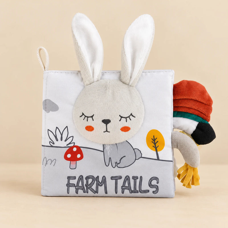 Farm Tails sensory cloth book with a plush rabbit face, soft ears and fabric tails.
