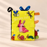 TibaToes Snuggle Stories Garden Fun cloth sensory book on a warm beige background.