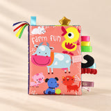 TibaToes Snuggle Stories Farm Fun cloth sensory book on a warm beige background.