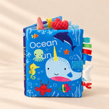 TibaToes Snuggle Stories Ocean Fun cloth sensory book on a warm beige background.