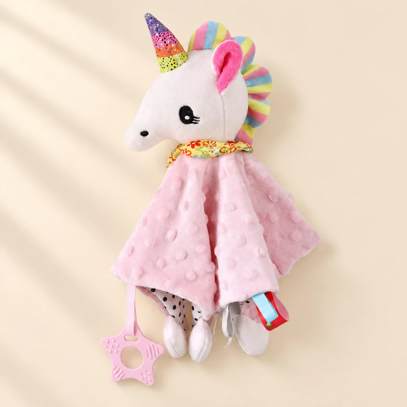 Unicorn comfort blanket with a rainbow mane, pink raised-dot cloth and attached pink star ring.