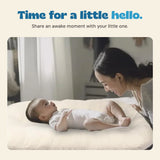 A parent shares a face-to-face moment with an awake baby in the cream lounger.