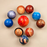 Ten planet-themed balls arranged around the larger red Sun, including eight planets and the Moon.