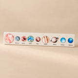 Soft Pink solar system puzzle strip with realistic planet artwork.