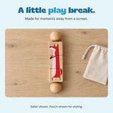 One Safari fox Spin and Match toy lies flat on a pale oak tabletop beside a beige pouch. Pouch shown for styling.