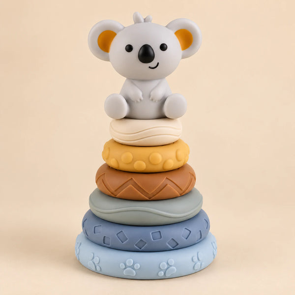 Koala stacking tower with six textured rings in pale blue, slate blue, sage, brown, yellow and ivory.