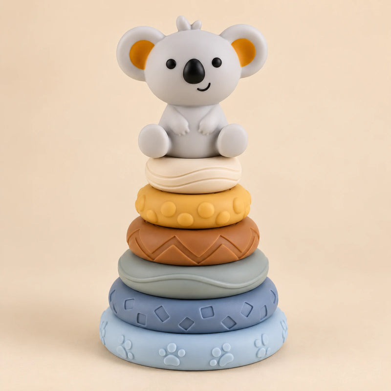 Koala stacking tower with six textured rings in pale blue, slate blue, sage, brown, yellow and ivory.