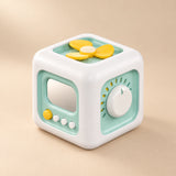 TibaToes Montessori Busy Cube in Green, showing its visible activity panels on a warm beige background.