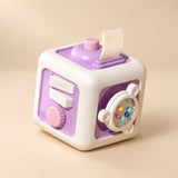 TibaToes Montessori Busy Cube in Starry Space Pup, showing its visible activity panels on a warm beige background.