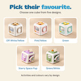 Five individual TibaToes Busy Cube choices: Off White/Yellow, Pink/Yellow, Green, Starry Space Pup and Green/White. Choose one cube; activities vary by design.
