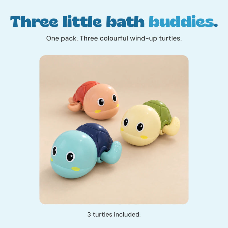 Three colourful wind-up turtles included together, shown on a smooth beige studio surface.