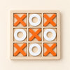 A wooden three-by-three tray with five orange crosses and four white rings.
