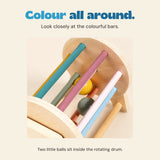 Close view of the drum’s coloured wooden bars and its yellow and grey-green balls.