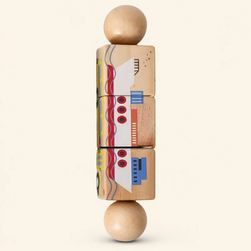 Wheel & Whirl wooden Spin and Match toy with three connected rotating blocks and two wooden ball ends, showing one printed face on smooth pale warm beige.