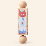 Career Crew wooden Spin and Match toy with three connected rotating blocks and two wooden ball ends, showing one printed face on smooth pale warm beige.