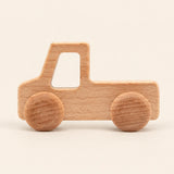 Truck wooden rolling toy on a smooth pale warm beige background, showing its original shape and wheel design.