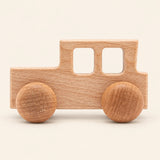 Locomotive wooden rolling toy on a smooth pale warm beige background, showing its original shape and wheel design.