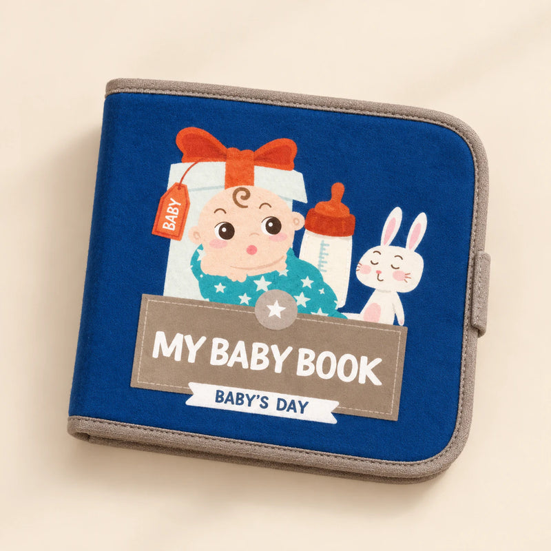 Dark-blue My Baby Book with its actual Baby’s Day cover showing a baby illustration, bottle and rabbit. Live variant: Sunny Bloom.