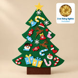 TibaToes felt Christmas Tree Play Set on a warm beige wall, with a badge showing the included 3 m fairy lights.