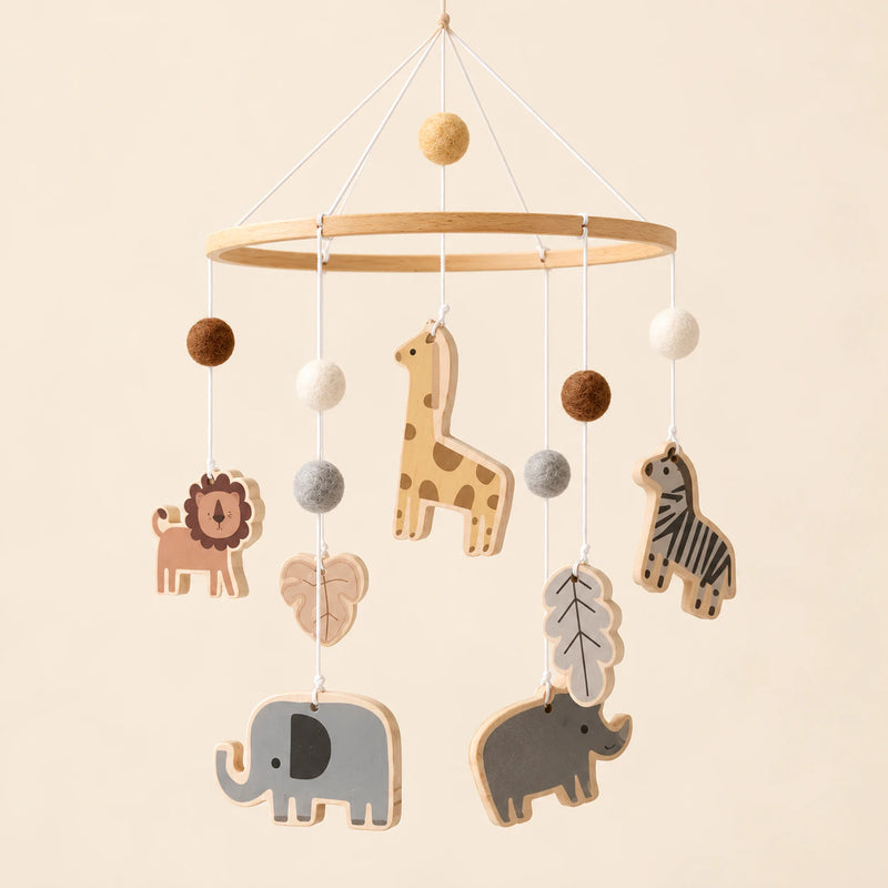 Animals hanging mobile with its source-matched wooden support, cords and individual charms on warm beige.