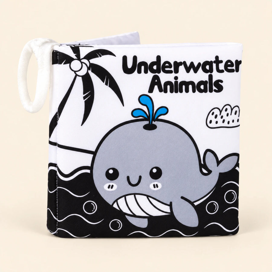 Underwater Animals soft cloth book with its printed front cover and white fabric loop on warm beige.