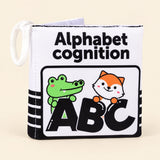 Letters soft cloth book with its printed front cover and white fabric loop on warm beige.