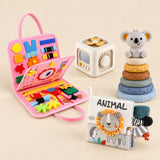 Mermaid Pink busy board with an off-white and yellow activity cube, ANIMAL lion cloth book and six-ring koala stacking tower on a calm beige background.