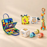 No-Screen Starter Kit with the Dinosaur Blue busy board, two soft books, giraffe rattle, busy cube and three turtles, arranged in a warm beige studio.