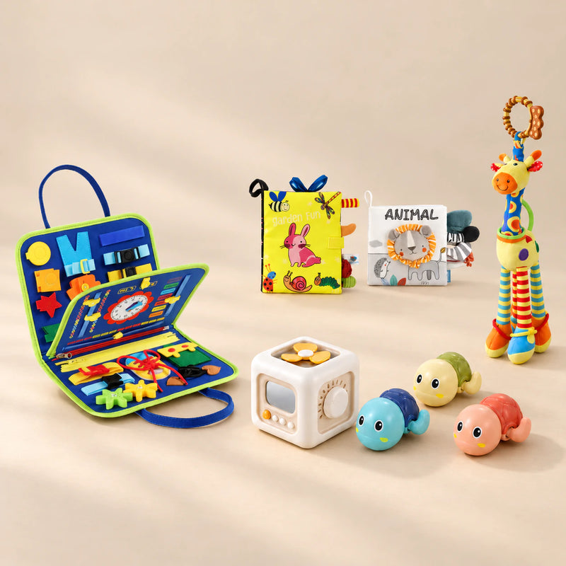 No-Screen Starter Kit with the Dinosaur Blue busy board, two soft books, giraffe rattle, busy cube and three turtles, arranged in a warm beige studio.