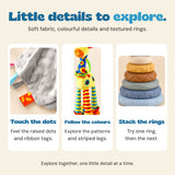 Close views of the blanket’s raised dot fabric and ribbon tags, the giraffe’s colourful neck and legs, and the tower’s textured rings.